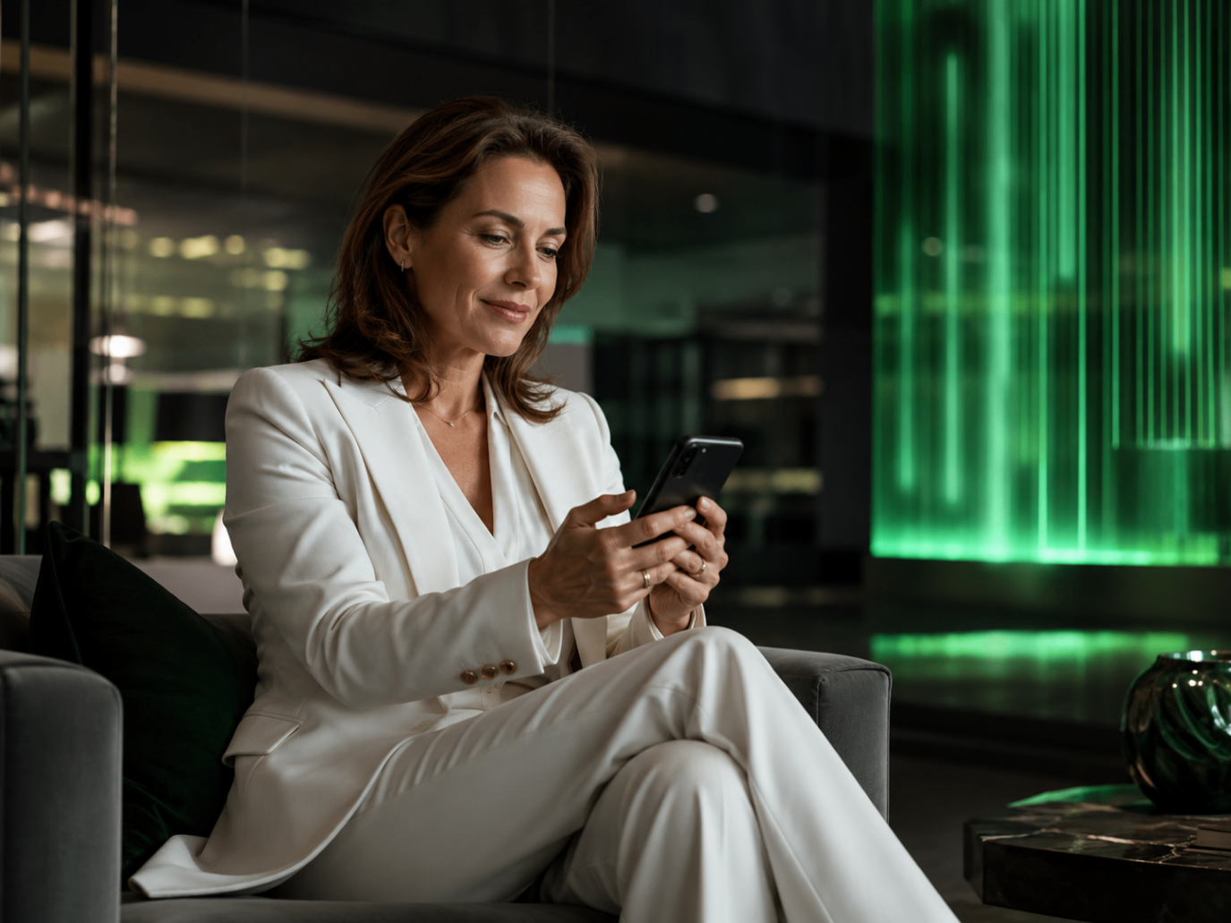 A professional reviewing financial information on a mobile device in a calm interior setting
