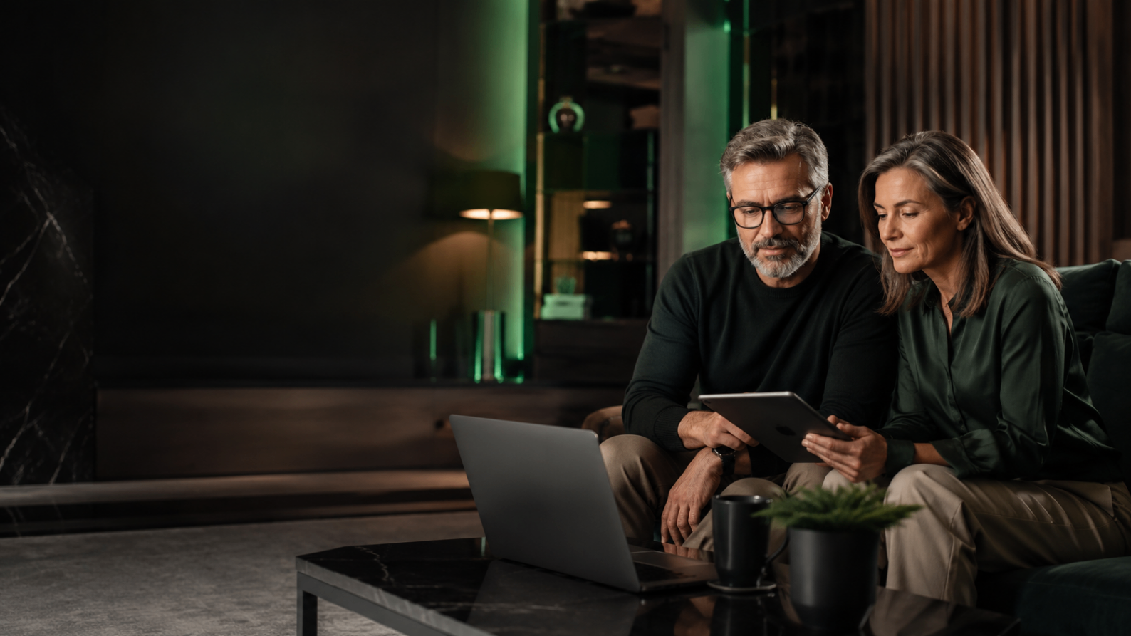 Mature users reviewing financial technology together in a calm, premium editorial setting